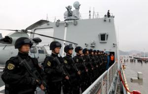 Soldiers of Chinese People's Liberation Army stand on deck before the fleet sets out for Aden, Yemen from Zhoushan